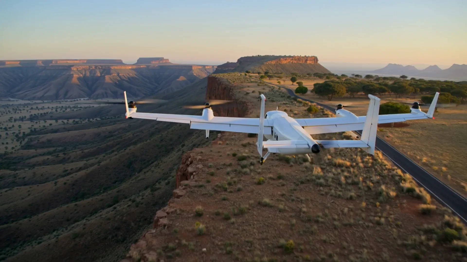 Illustrative fixed-wing VTOL cargo aircraft above a South African landscape